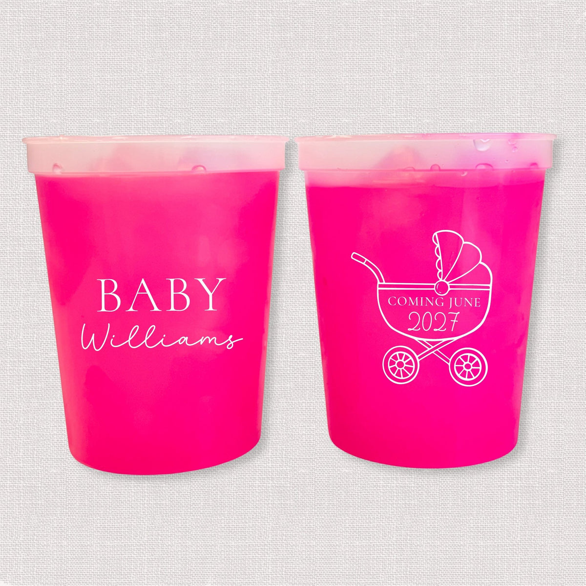 Magenta color changing baby shower stadium cups with Baby Williams script and baby carriage due date design
