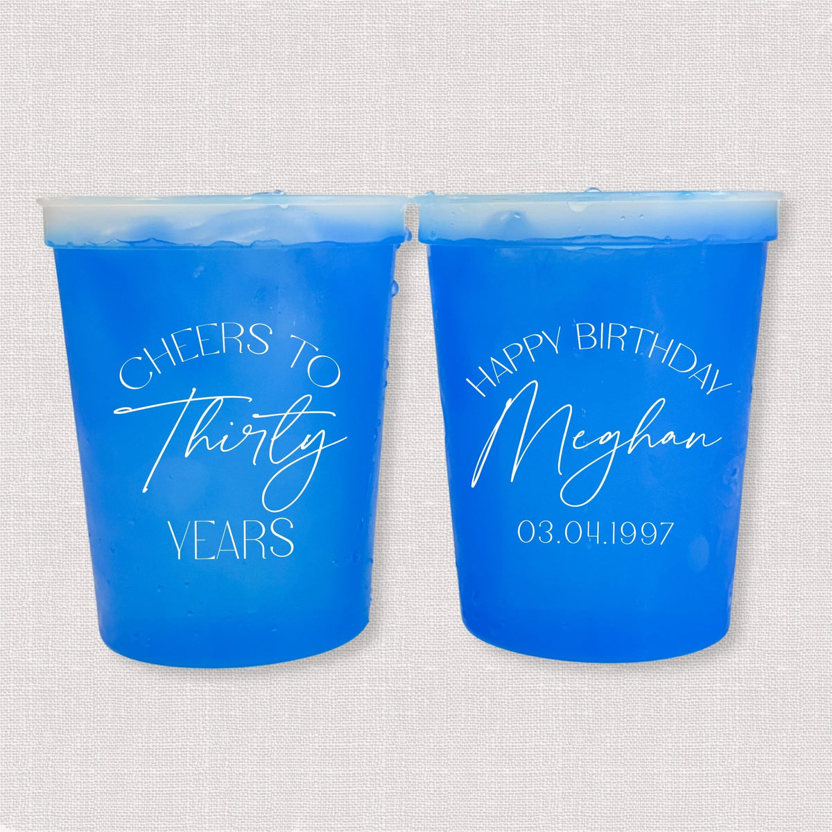 Blue color changing birthday stadium cups with Cheers to Thirty Years arch and Happy Birthday Meghan personalization