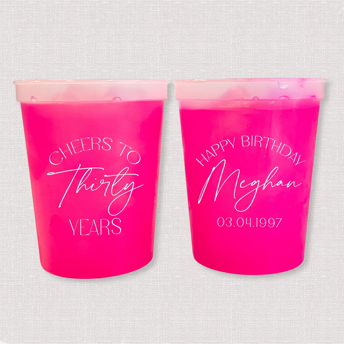 Magenta color changing birthday stadium cups with Cheers to Thirty Years arch and Happy Birthday Meghan personalization