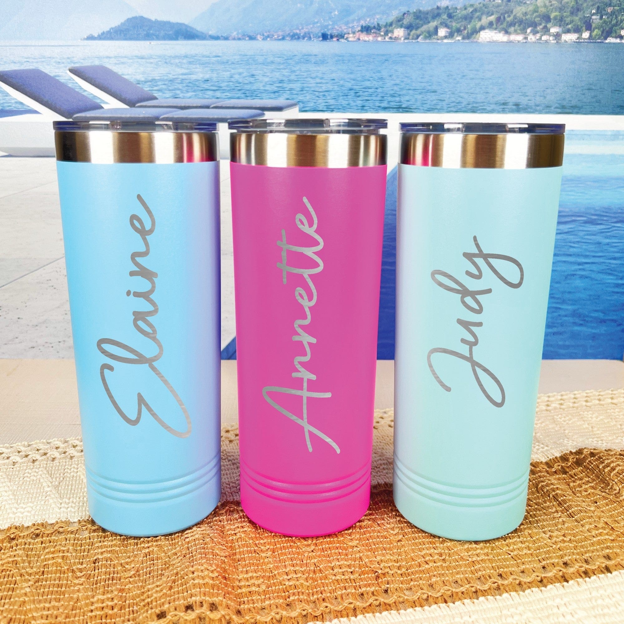 Three personalized skinny tumblers made of insulated stainless steel with clear lids, displayed in light blue, hot pink, and mint green colors, ideal for wedding party gifts or bridal shower favors.
