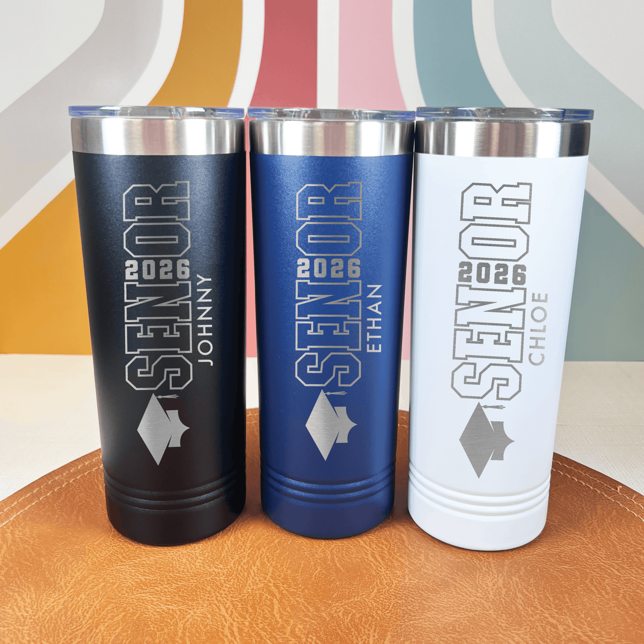 Black, blue, and white personalized senior graduation tumblers with class year and custom names in silver foil print design
