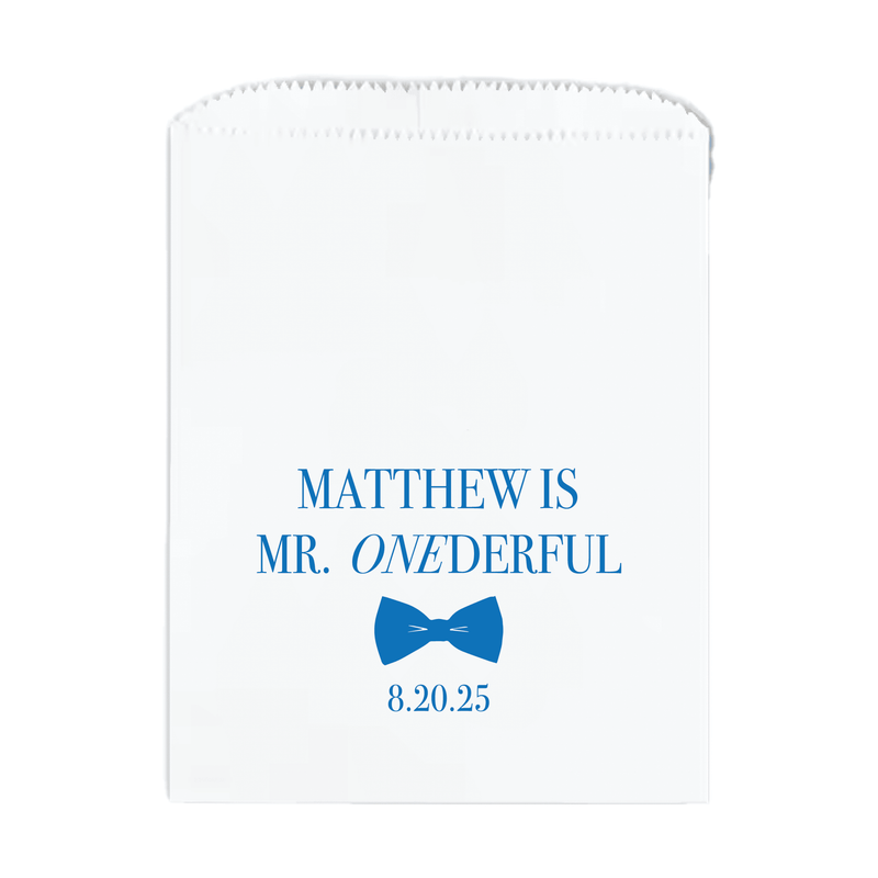 White treat bag with blue text reading "Matthew is Mr. Onderful" and a blue bow tie icon with date 8.20.25