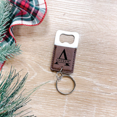 A personalized brown faux leather bottle opener keychain features a silver metal opener and keyring, designed for practical use and gifting.