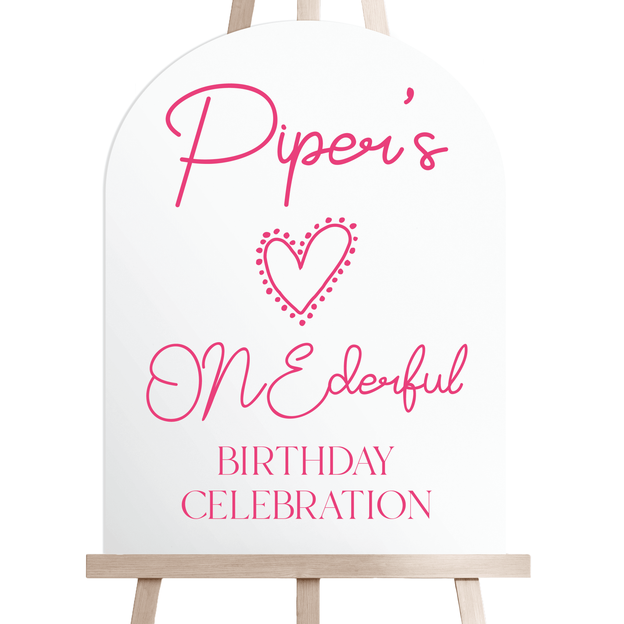 White welcome sign with pink script text reading "Piper's ONEderful Birthday Celebration" and decorative heart design, displayed on wooden easel.